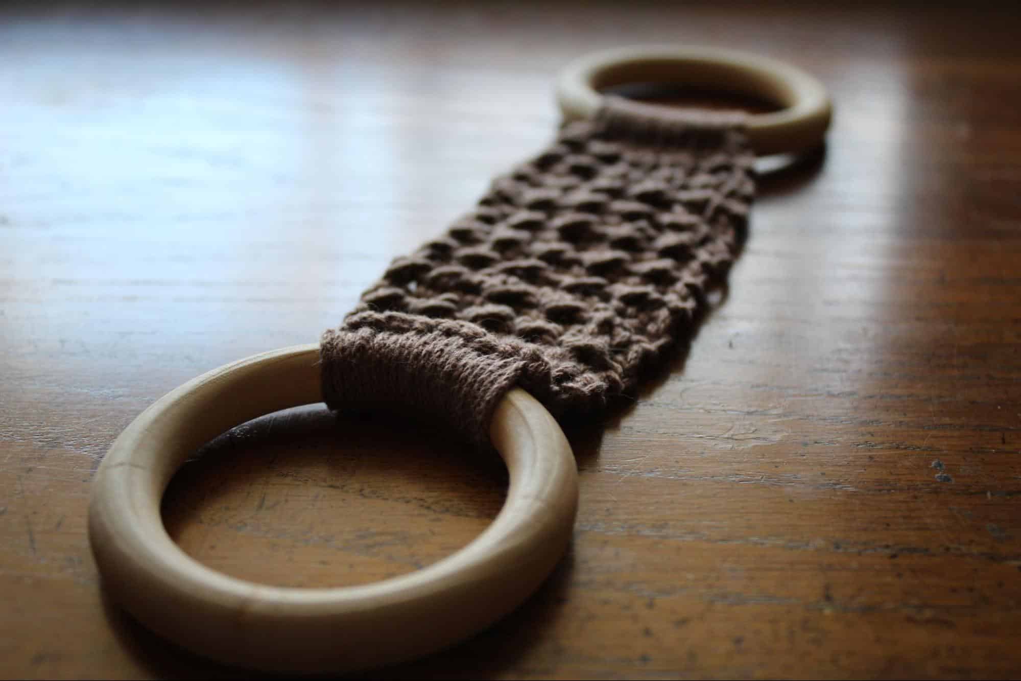 Completed base on wood Woodland Dishcloth Hanger completed in brown with wood background. Wooden rings.