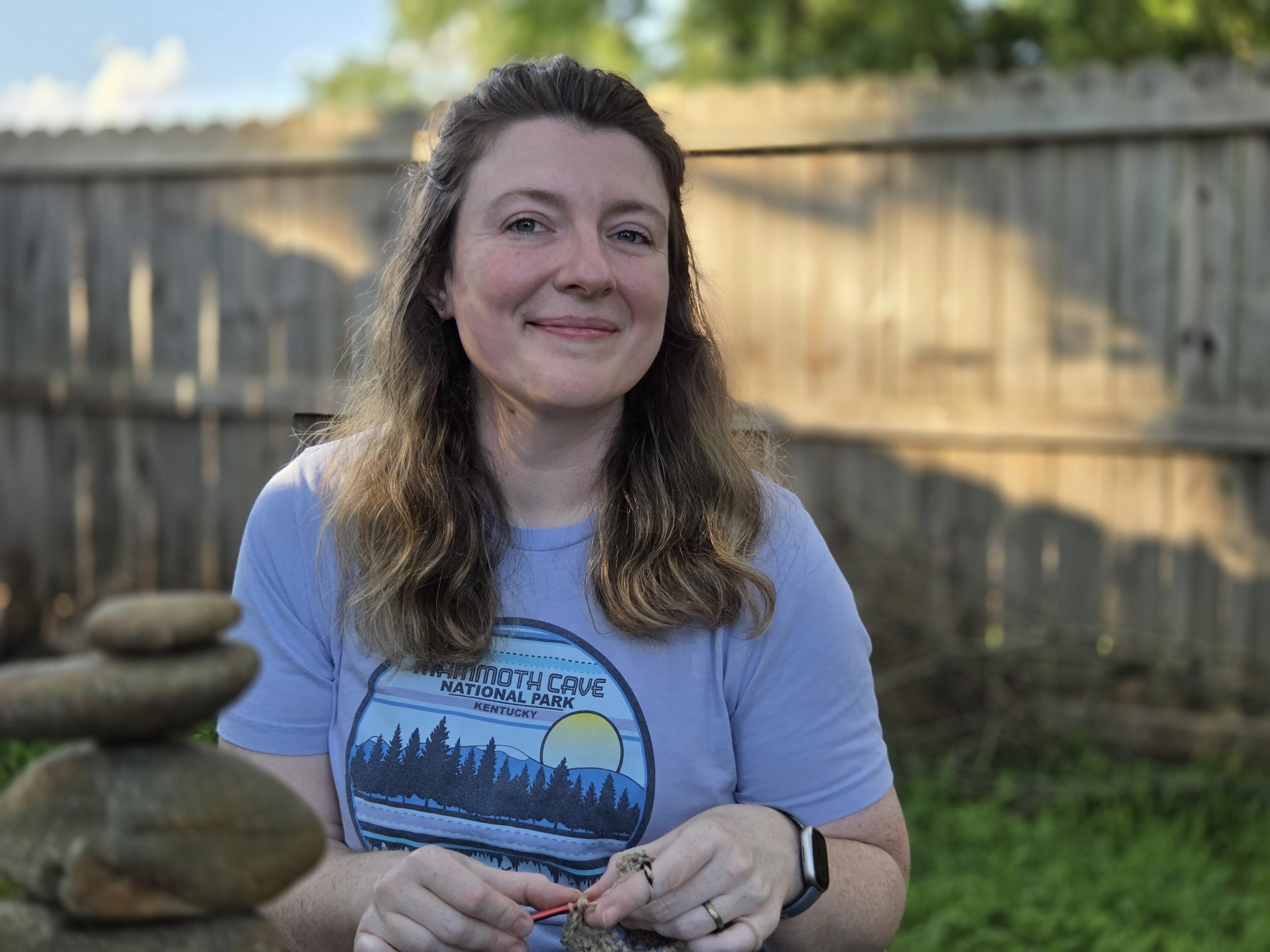 Crochet Mindfulness with Yarnful Mind. Picture of the creator working on granny squares.