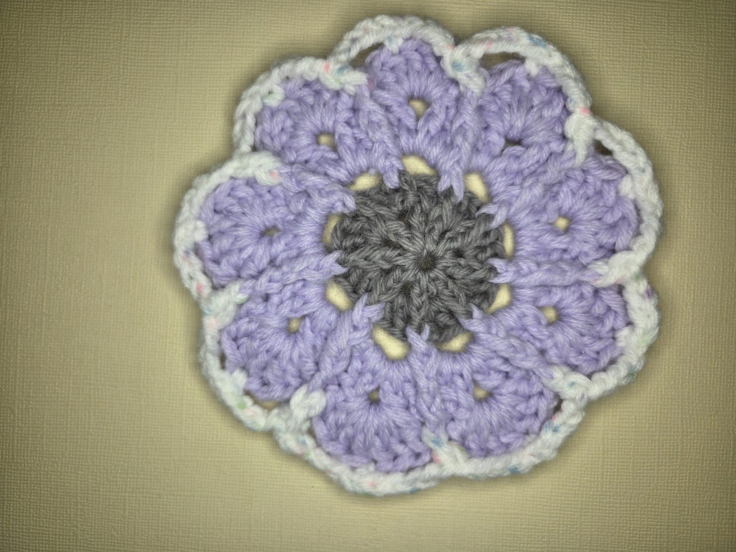 Crochet Geometric Shape Geometric crochet shape in lavender, grey, and white.