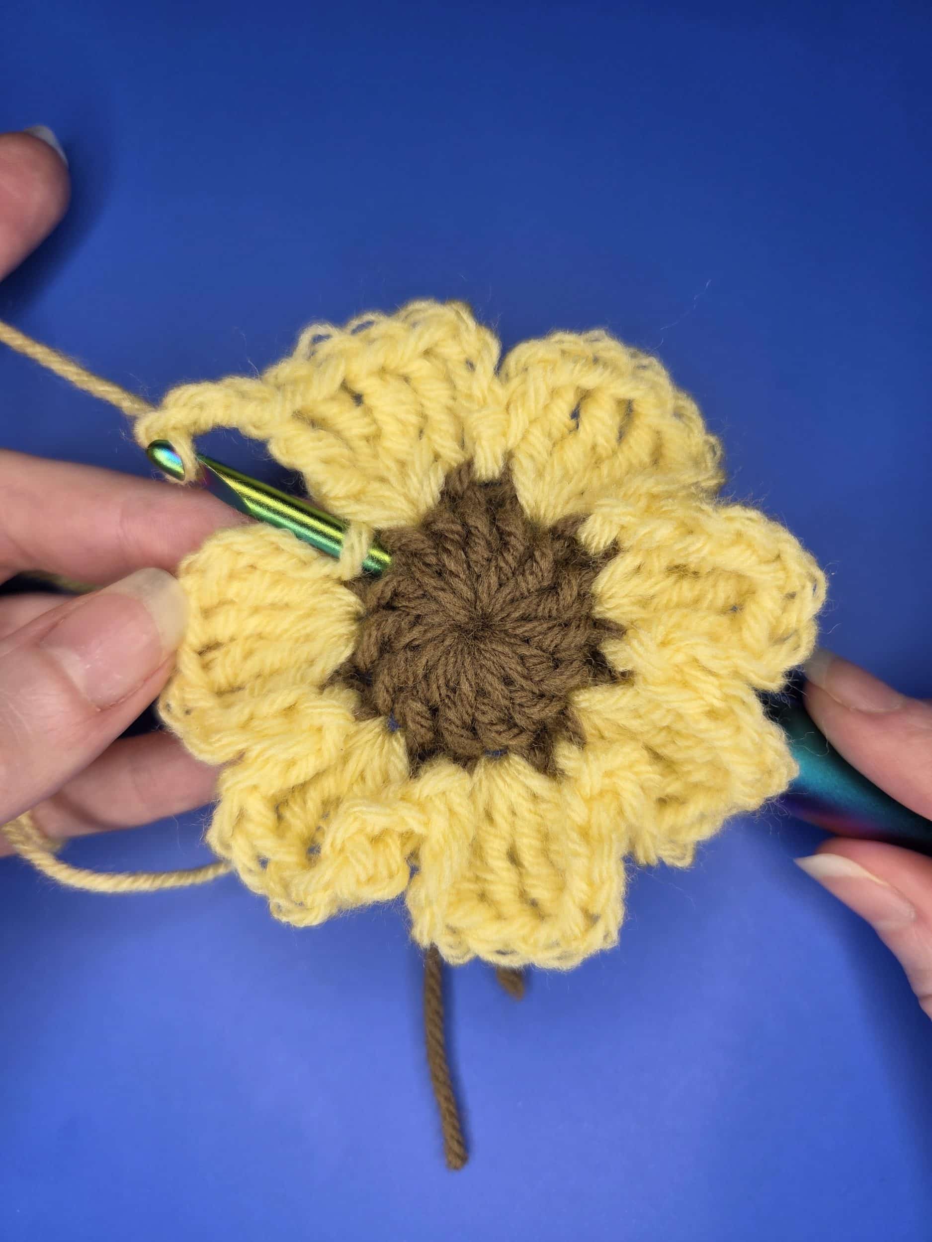 How to place your hook for round 3 of flower granny square free crochet pattern. Front view.