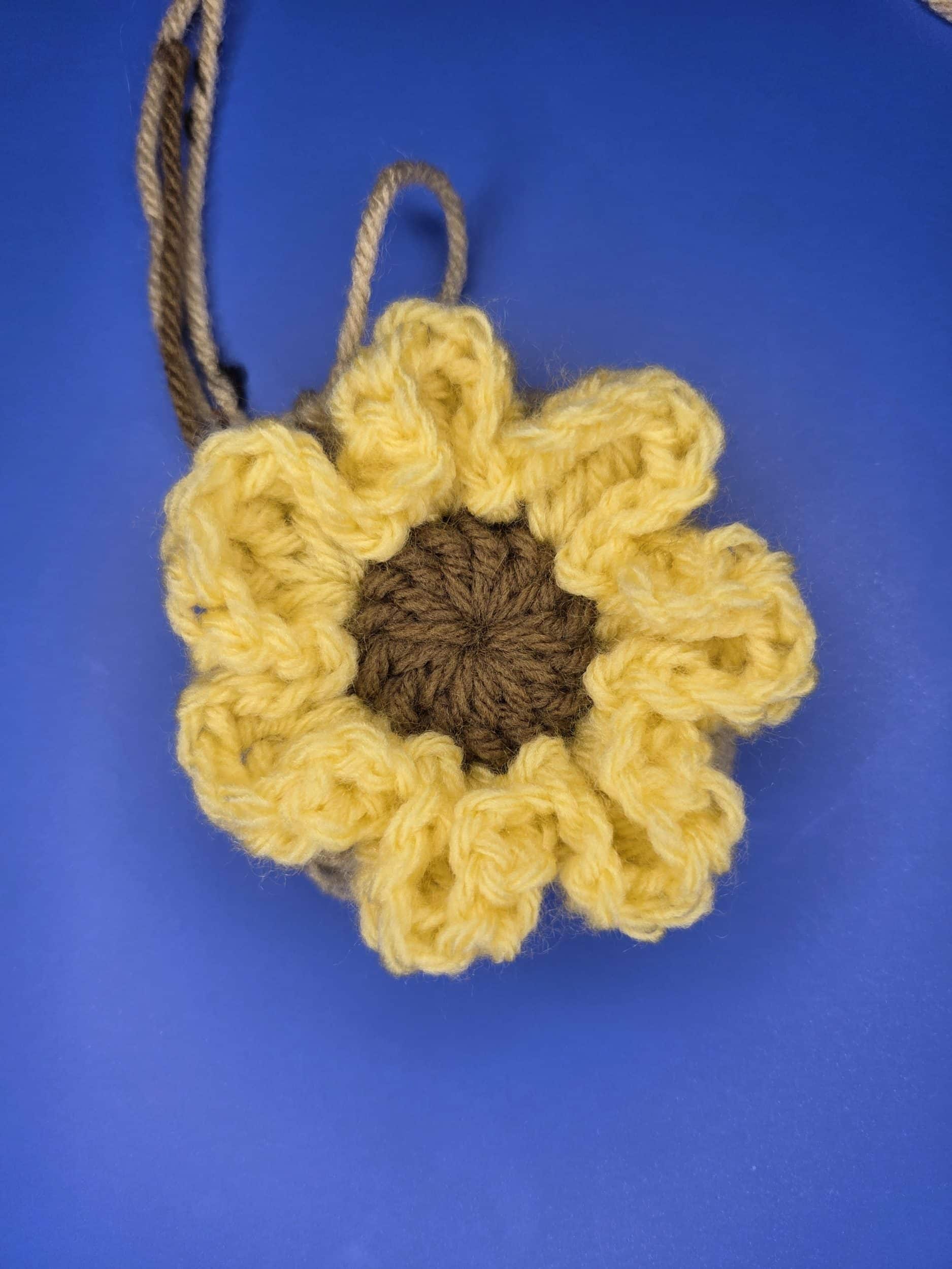 Completed round 4 of free flower granny square pattern. Front view.