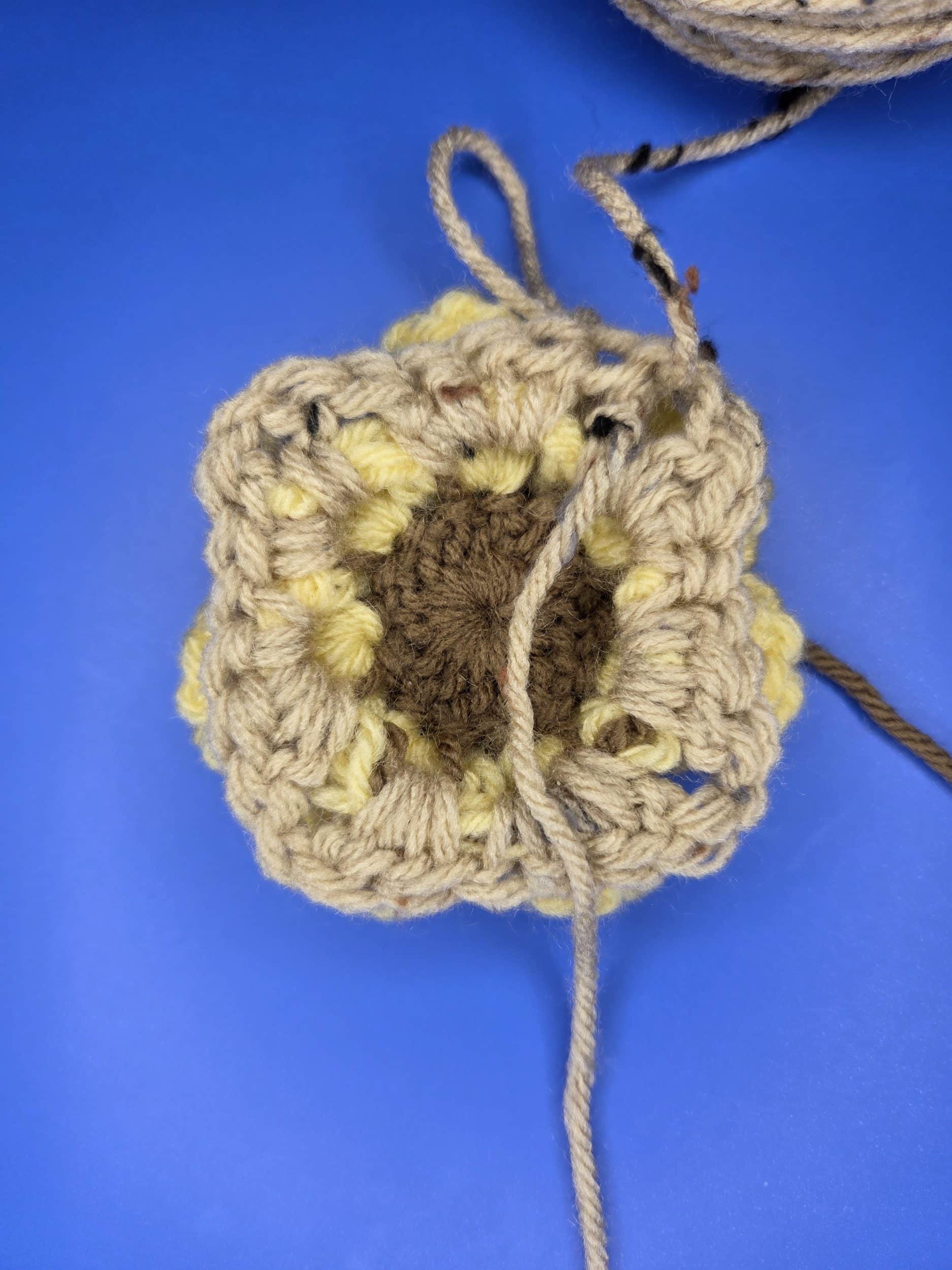 Completed round 4 of free flower granny square pattern. Back view.