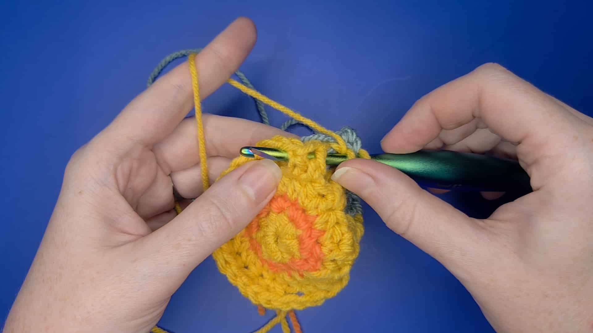 image shows the correct placement of the hook when working the fpdc* stitch in the sunny square pattern