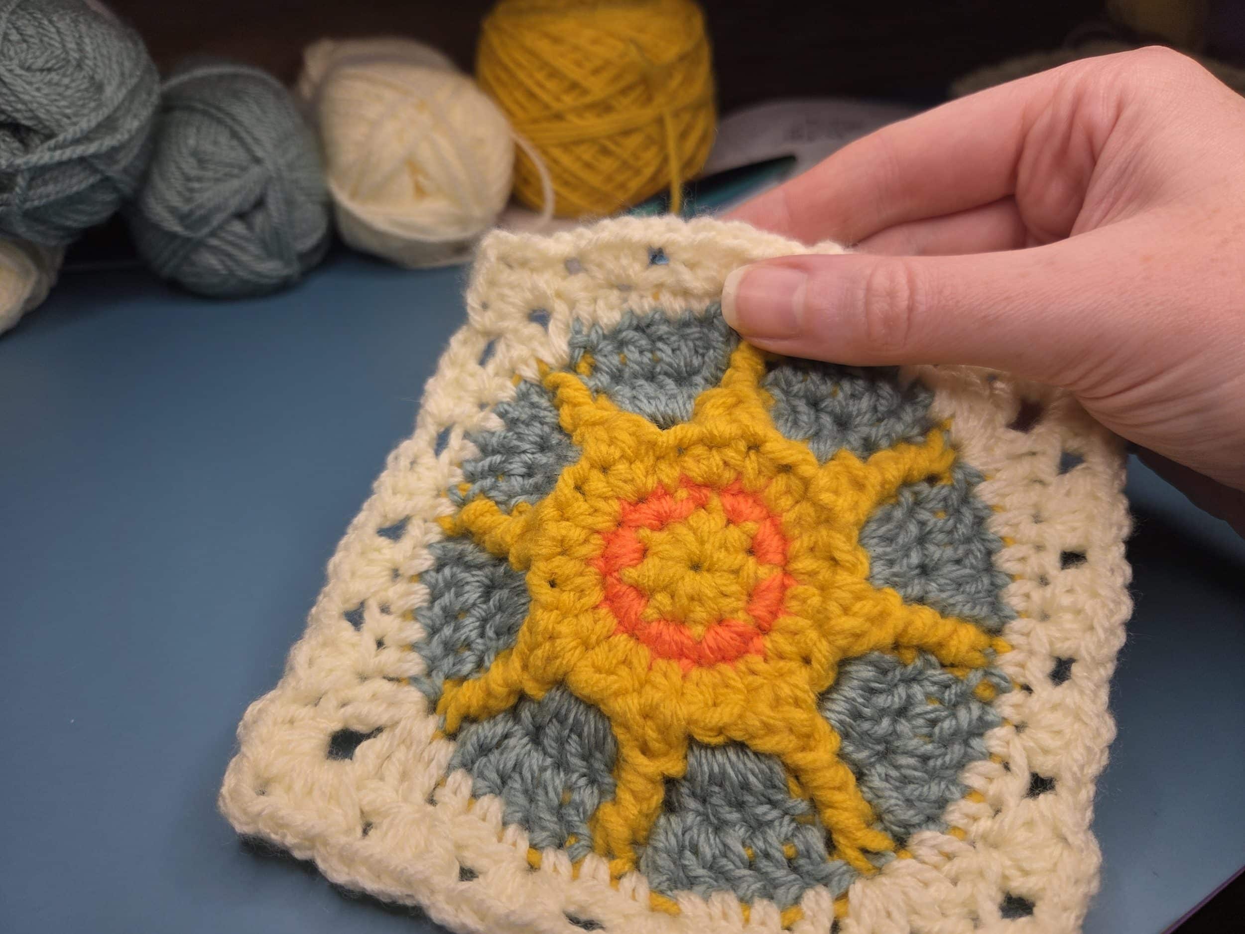 Showing the completed free sun crochet square